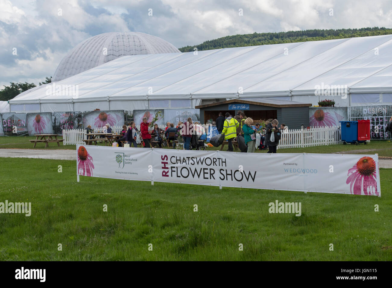 Showground at first RHS Chatsworth Flower Show (people having refreshments at café near floral marquee) Chatsworth House, Derbyshire, England, UK. Stock Photo