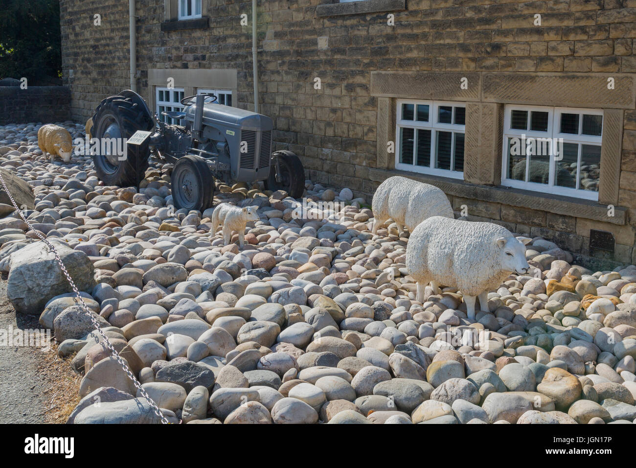 Ornamental sheep and a vintage grey Ferguson tractor outside The George Hotel in Hathersage, Peak District, Derbyshire, England, UK Stock Photo