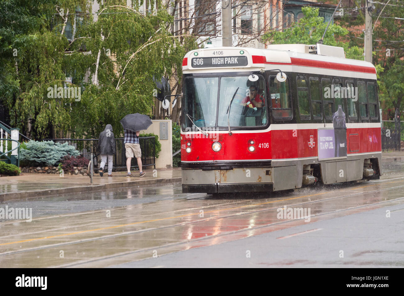 Toronto, Canada - 25 June 2017: Street car in Downtown Toronto going on Carlton street in the rain Stock Photo