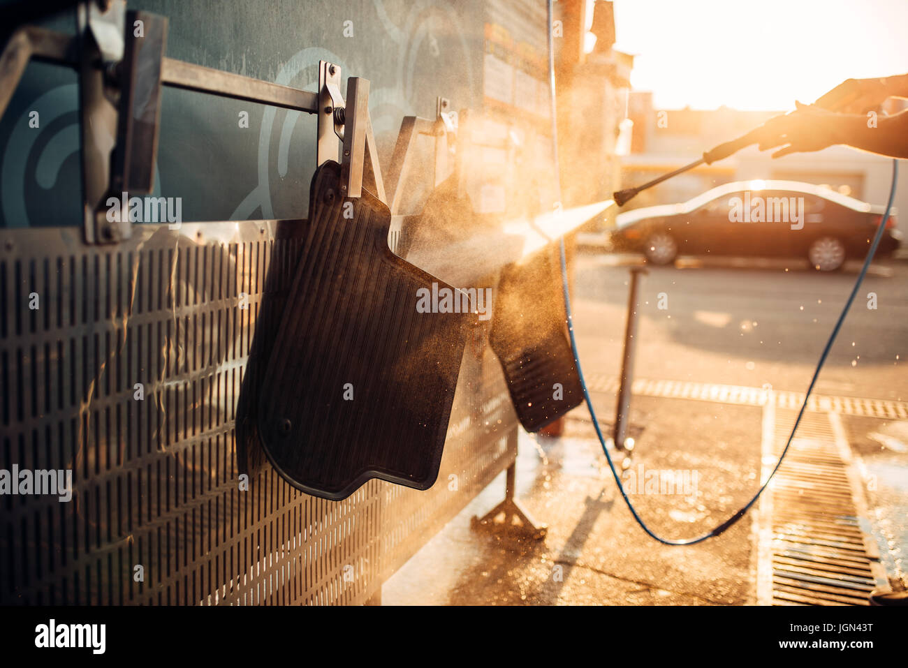 Car carpets washing with high pressure washer. Car-wash station Stock Photo