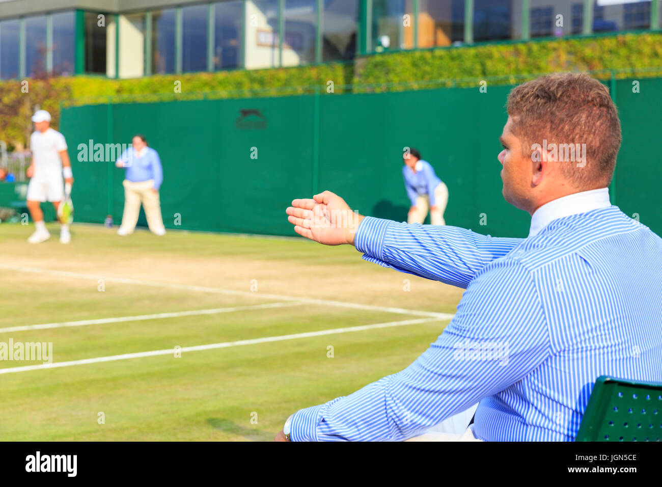A  Wimbledon line judge, or line umpire, calls a shot during a match at the Wimbledon Tennis Championships 2017, All England Lawn Tennis and Croquet C Stock Photo