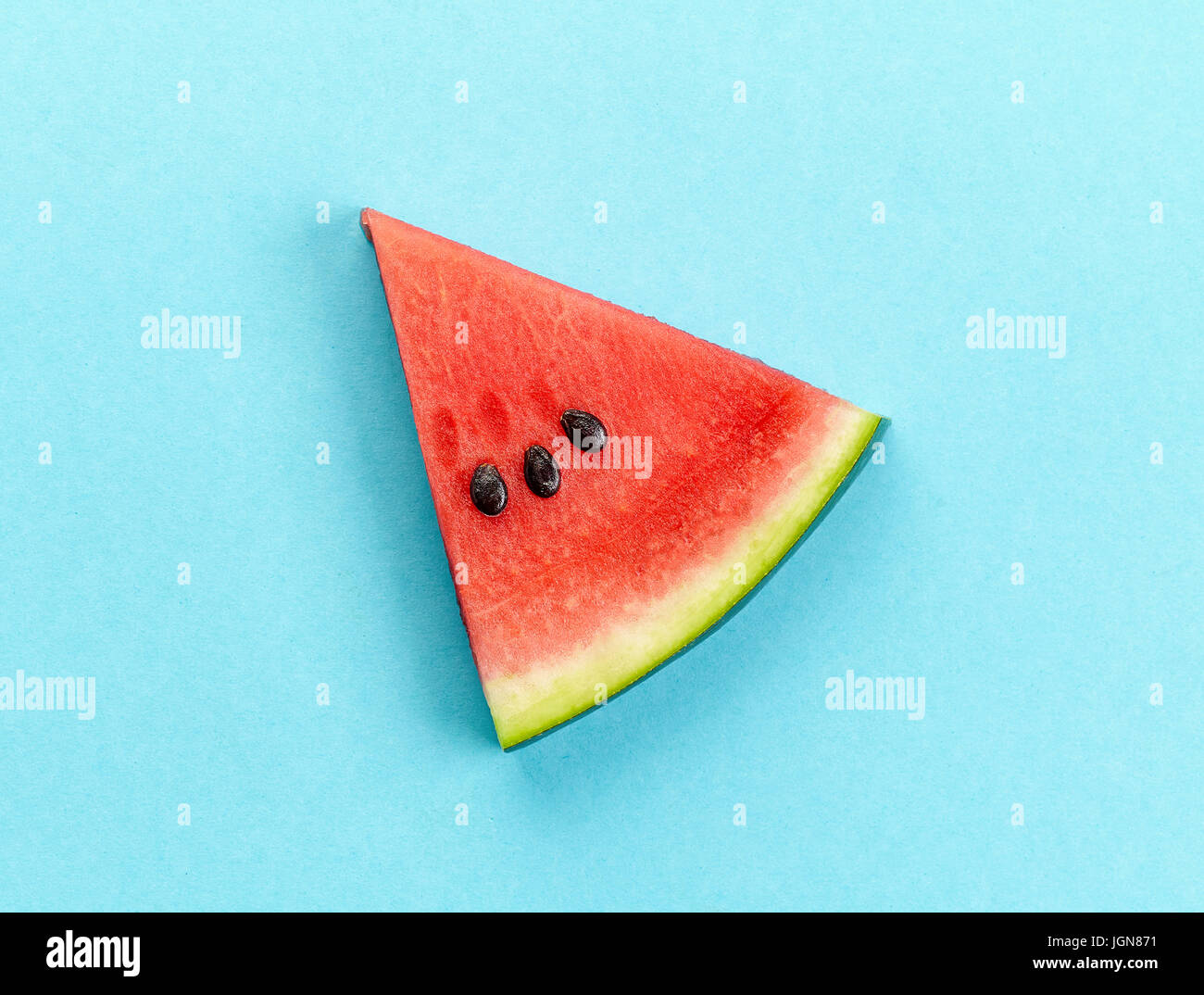 piece of watermelon on blue background Stock Photo - Alamy