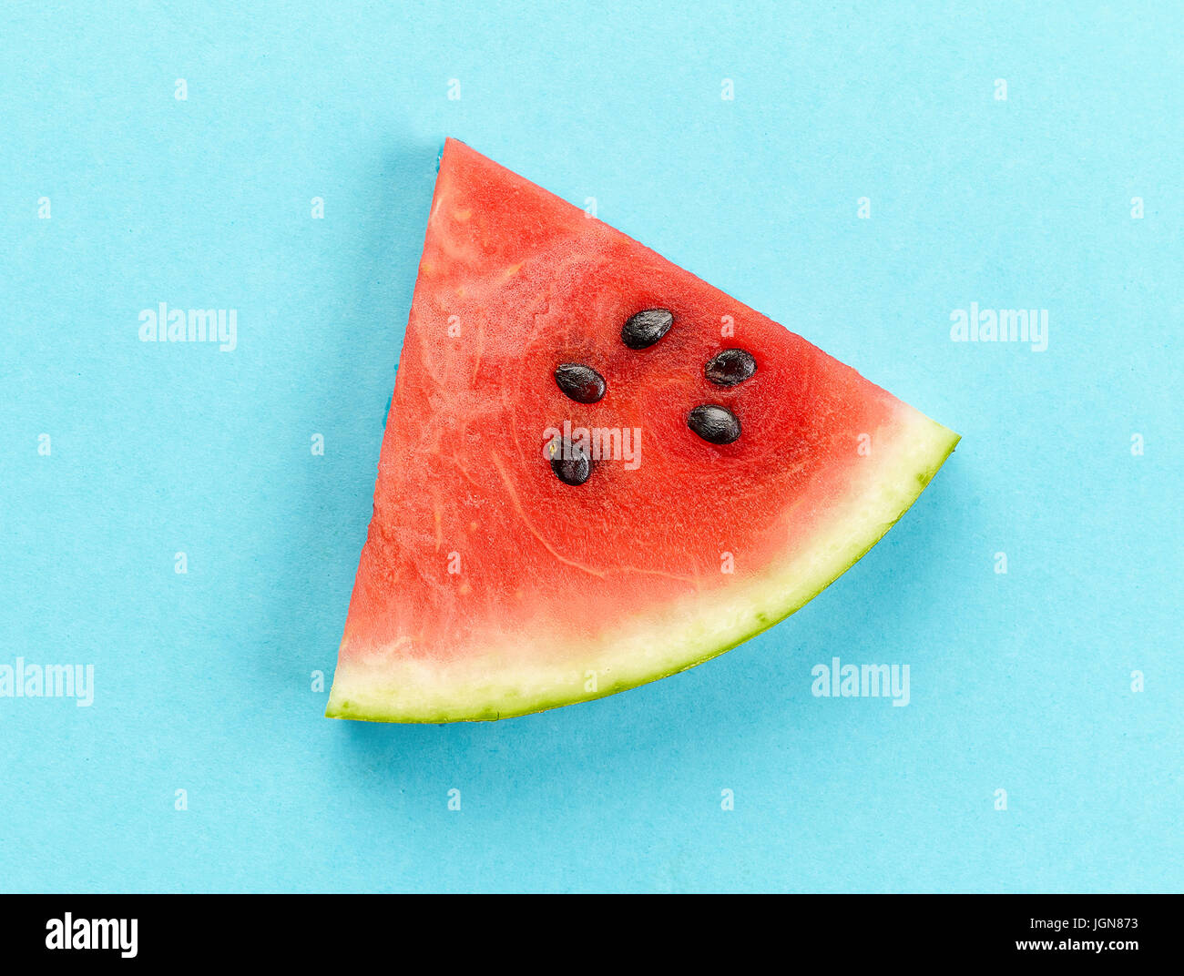 piece of watermelon on blue background Stock Photo - Alamy