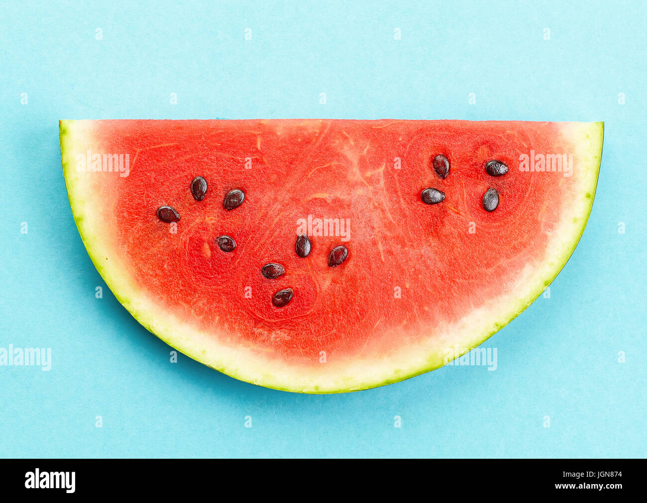 piece of watermelon on blue background Stock Photo - Alamy