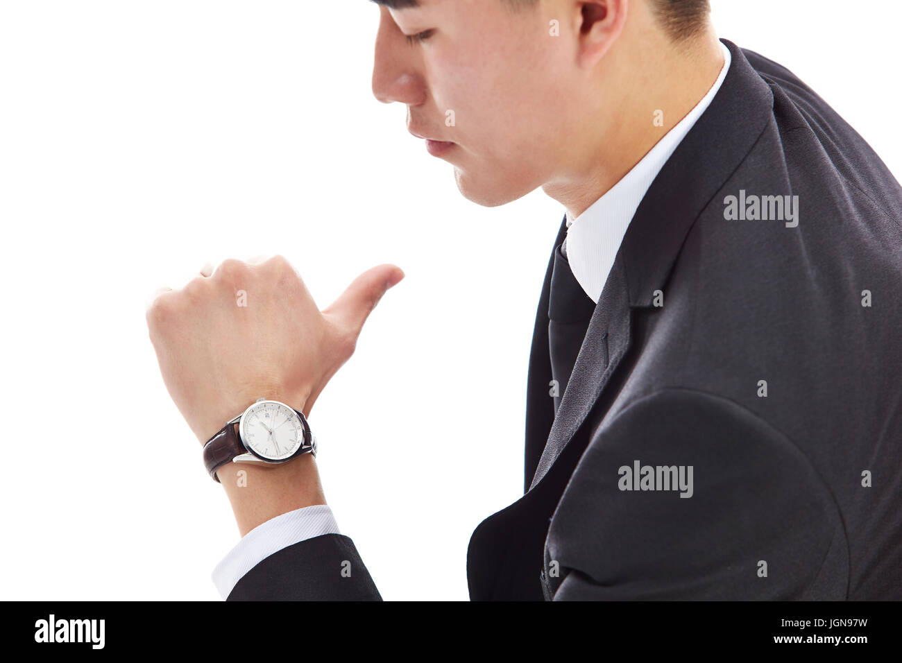 young asian businessman in formal wear looking at watch, isolated on white background. Stock Photo