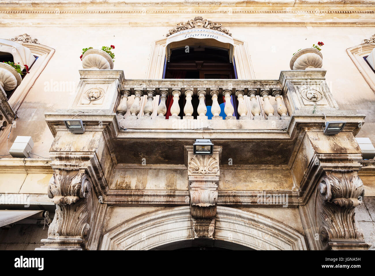 TAORMINA, ITALY - JUNE 29, 2017: facade of medieval palace on main street Corso Umberto I in Taormina city. Taormina is resort town on Ionian Sea in S Stock Photo