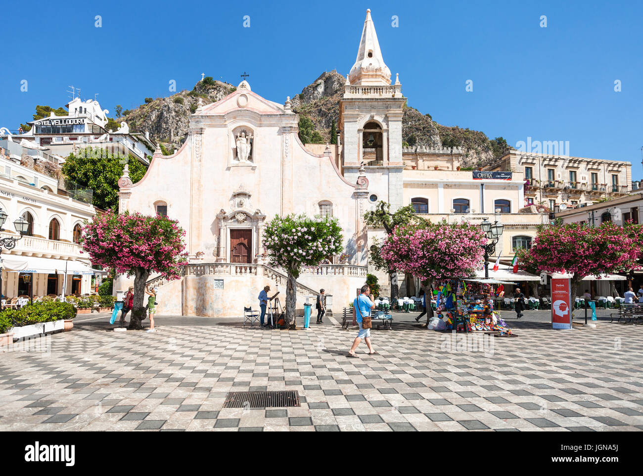 TAORMINA, ITALY - JUNE 29, 2017: tourists on square Piazza 9 Aprile near church Chiesa di San Giuseppe in Taormina city. Taormina is resort town on Io Stock Photo