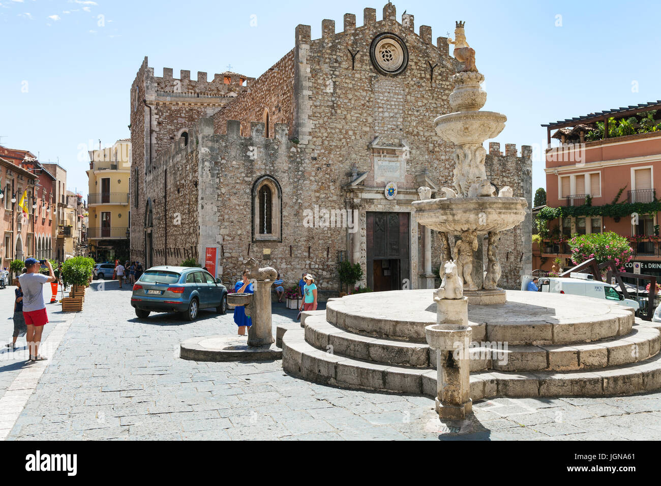 TAORMINA, ITALY - JUNE 29, 2017: tourists on Piazza dell Duomo near fountain in Taormina city. Taormina is resort town on Ionian Sea in Sicily Stock Photo