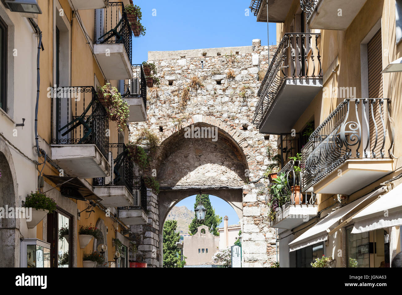 TAORMINA, ITALY - JUNE 29, 2017: medieval arch of old gateway Porta Catania in Taormina city. Taormina is resort town on Ionian Sea in Sicily Stock Photo