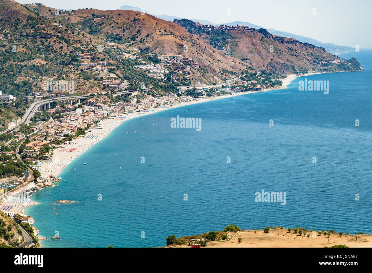travel to Sicily, Italy - above view of Letojanni resort village of shore of Ionian Sea from Taormina city in summer day Stock Photo