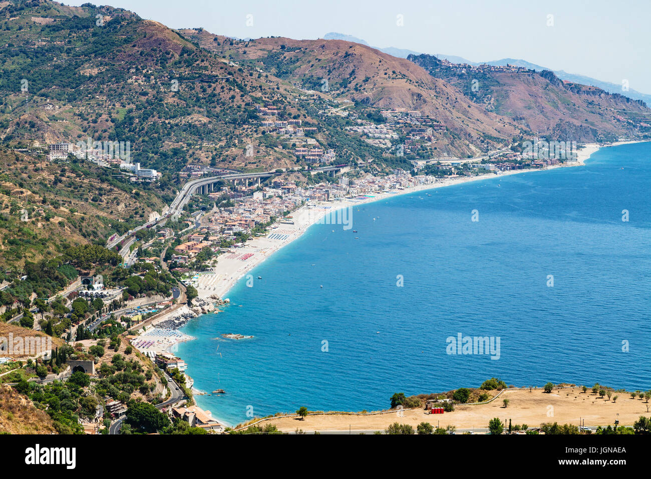 travel to Sicily, Italy - above view of Letojanni resort town of shore of Ionian Sea from Taormina city in summer day Stock Photo