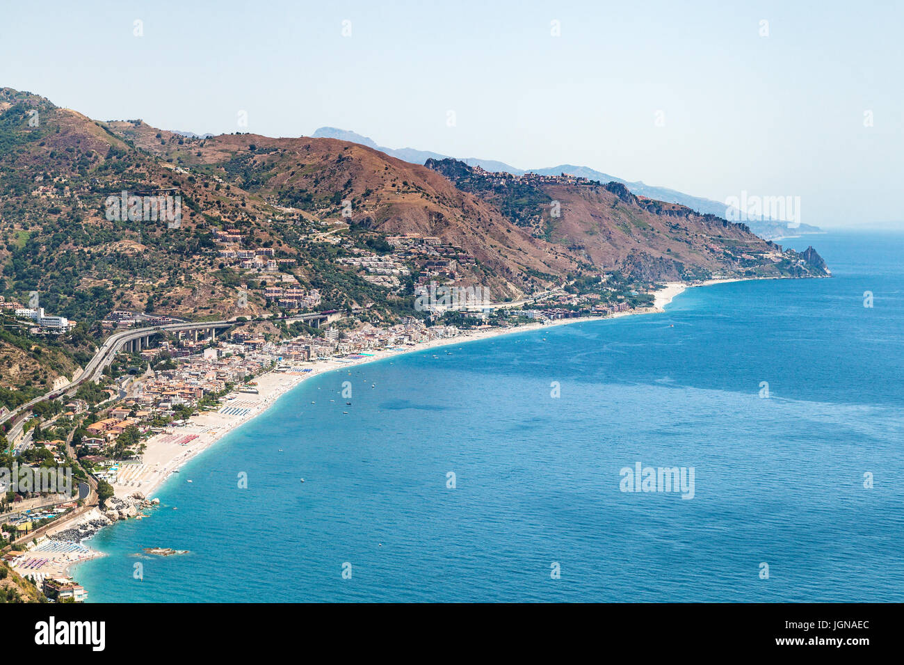travel to Sicily, Italy - above view of Letojanni resort village of coast of Ionian Sea from Taormina city in summer day Stock Photo