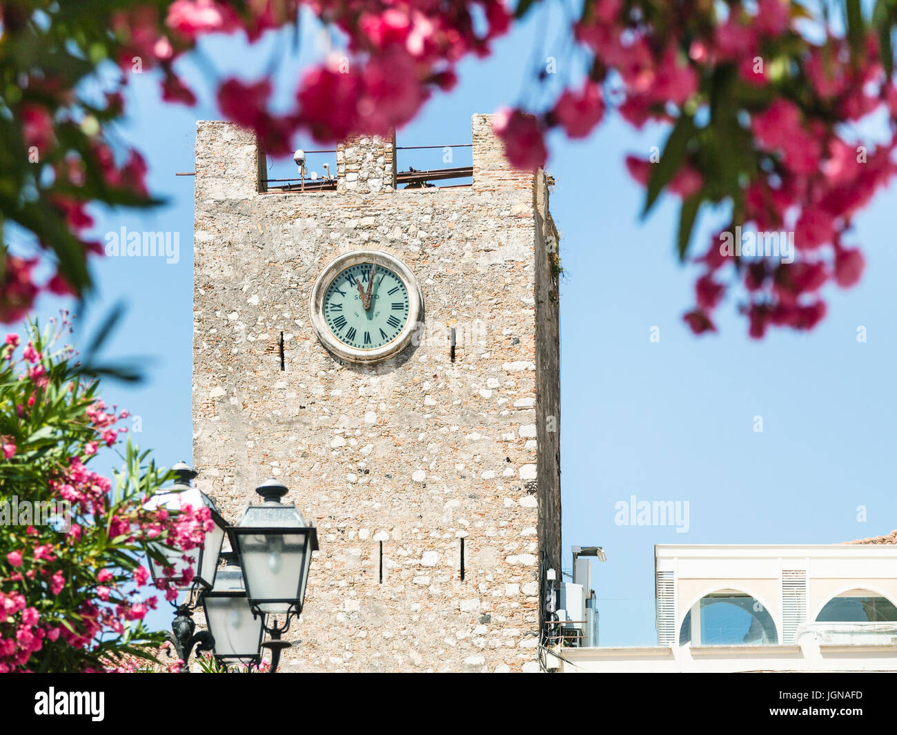 travel to Sicily, Italy - view of medieval clock tower (Torre dell Orologio) at Piazza IX Aprile in Taormina city in summer day Stock Photo