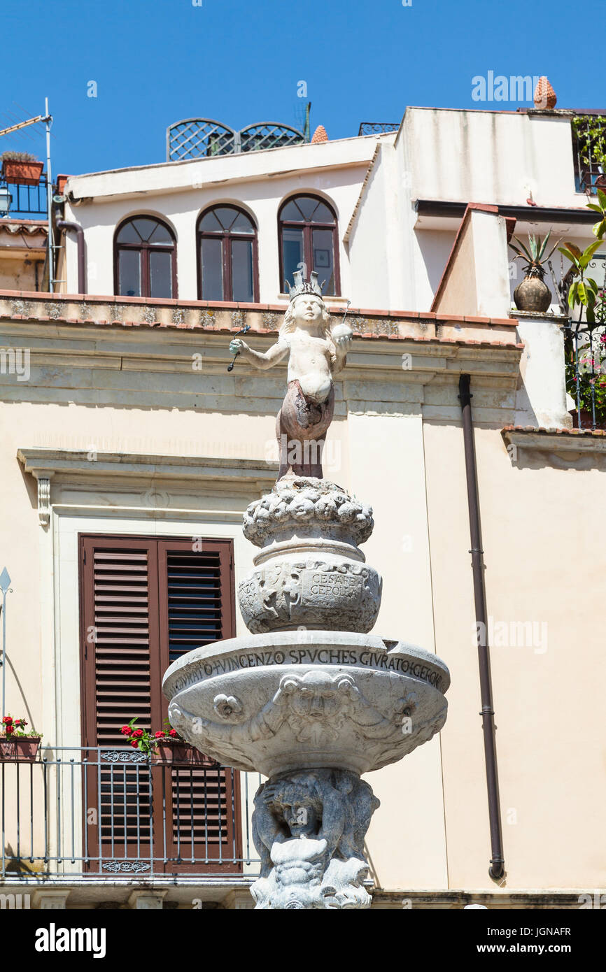 travel to Sicily, Italy - top figure of baroque style fountain (Quattro Fontane di Taormina) on Piazza Del Duomo in Taormina city in summer day Stock Photo