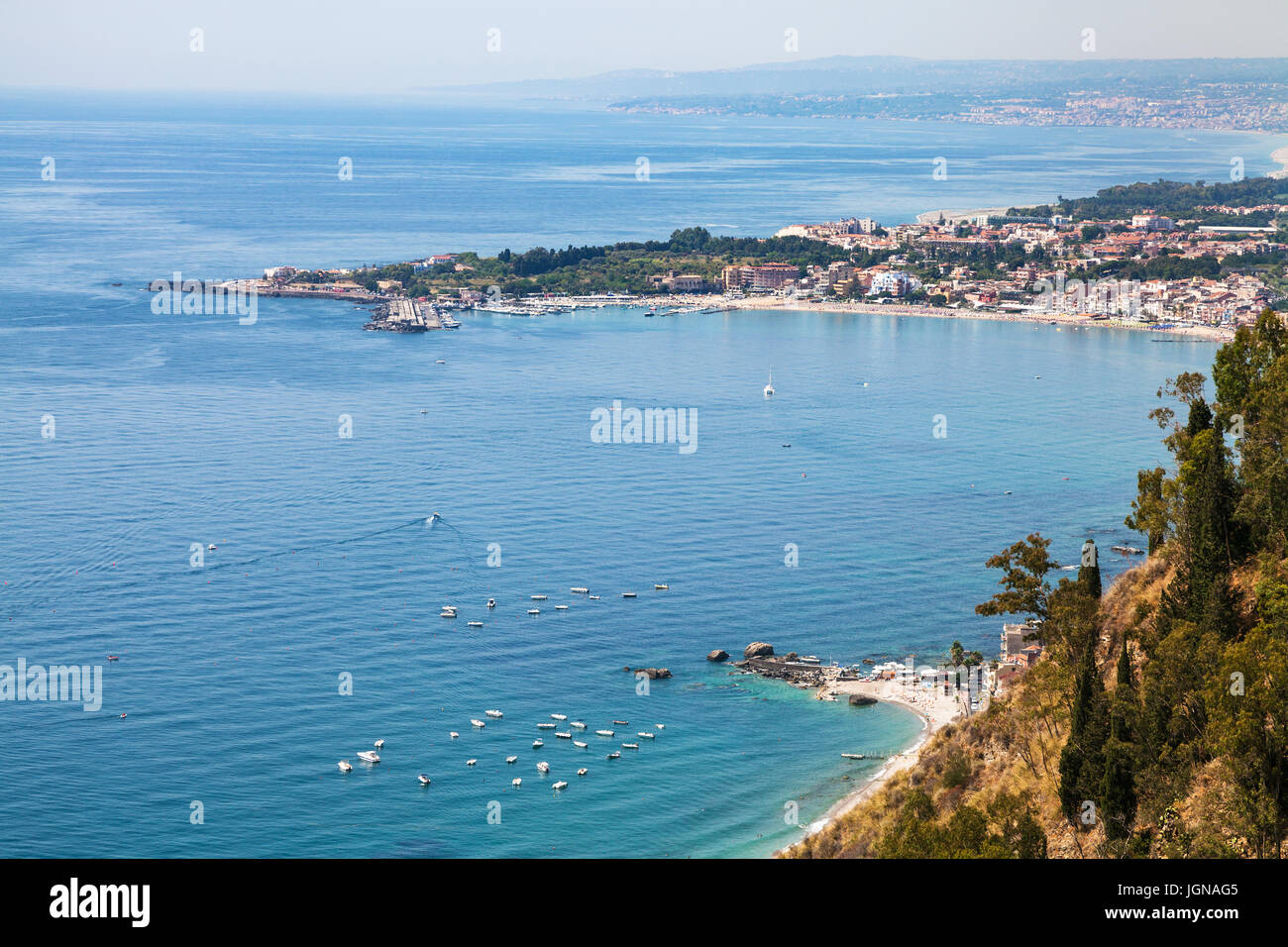 travel to Sicily, Italy - view of Giardini Naxos town on beach of Ionic sea from Belvedere viewpoint at Piazza IX Aprile in Taormina city Stock Photo