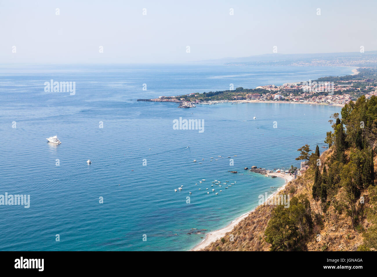 travel to Sicily, Italy - view of Giardini Naxos town on coast of Ionic sea from Belvedere viewpoint at Piazza 9 Aprile in Taormina city Stock Photo