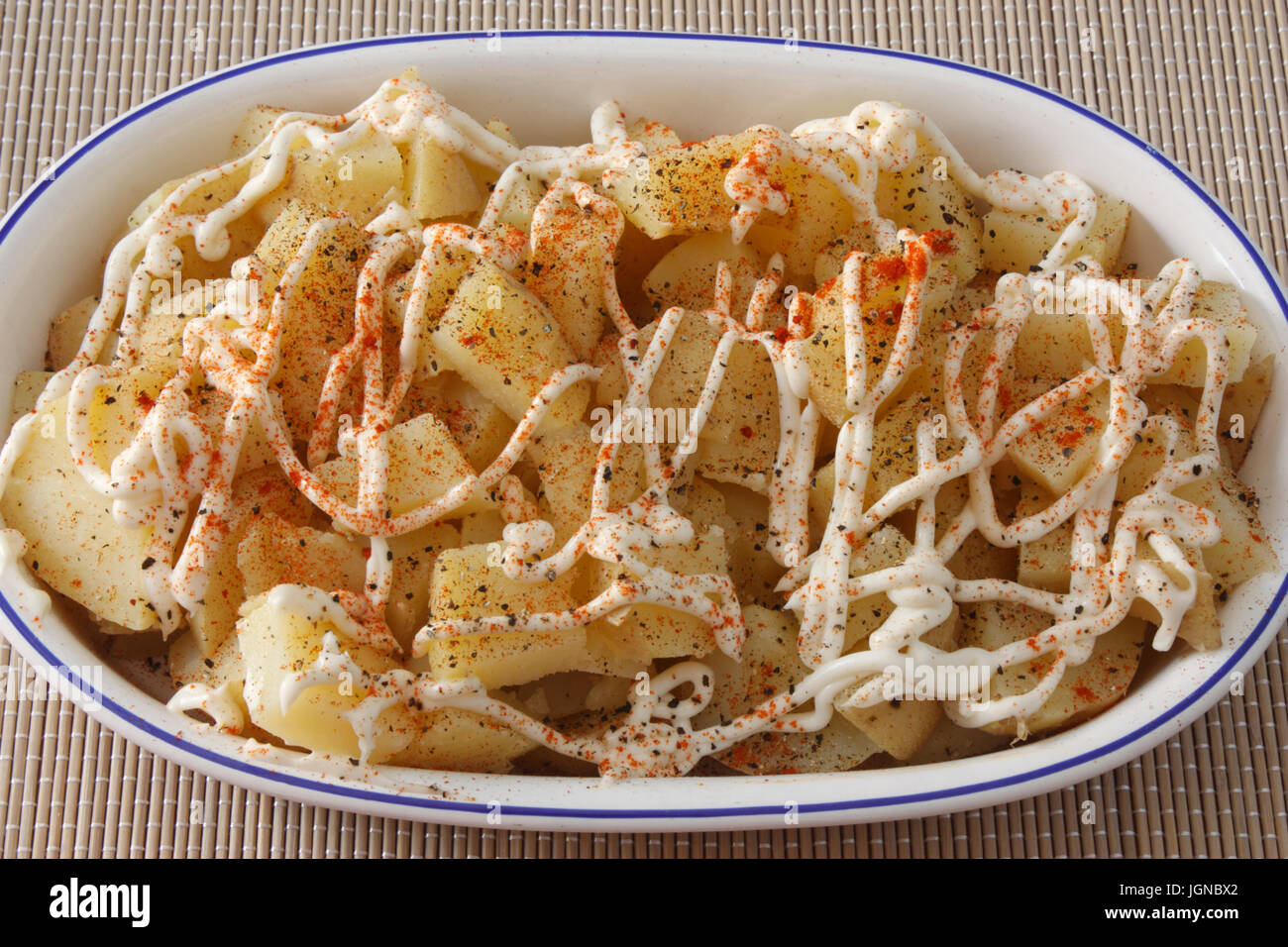 Close-up of potato salad with mayonnaise in oval dish Stock Photo