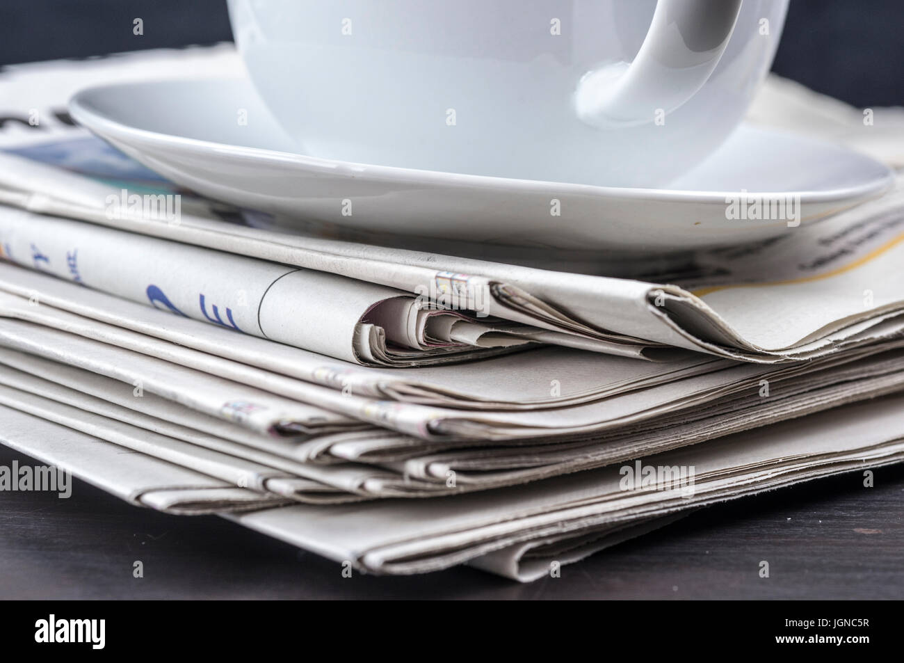 Close up of coffee on top of newspapers Stock Photo