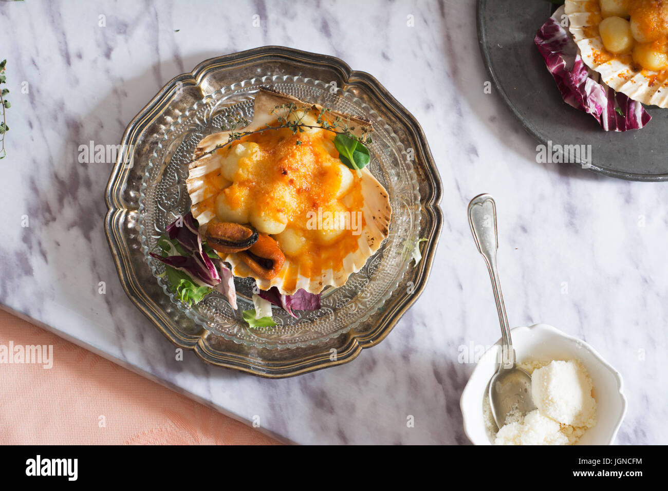 Gnocchi pasta with mussels, tomato and cream room, in vieira shell