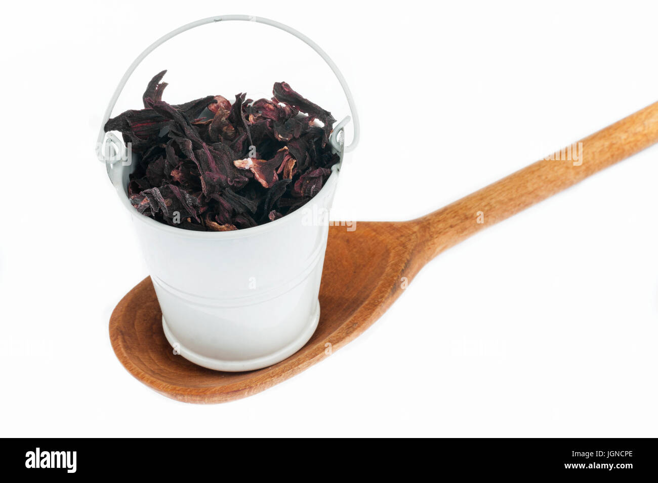 Full bucket of dry hibiscus stands in a wooden spoon. The concept of food. Stock Photo