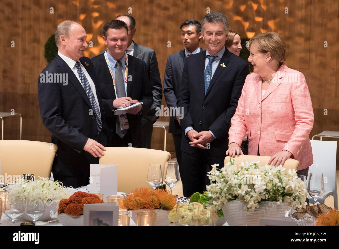 Russian President Vladimir Putin, left, talks with German Chancellor Angela Merkel and Argentine President Mauricio Macri before the start of a dinner for world leaders attending the first day of the G20 Summit meeting at the Elbphilharmonie concert hall July 7, 2017 in Hamburg, Germany.   (Bundesregierung/Bergmann via Planetpix) Stock Photo
