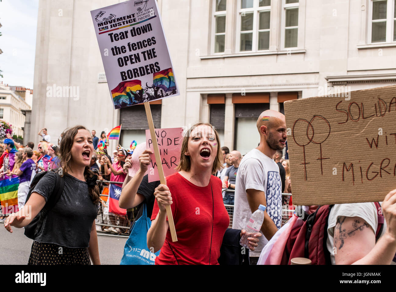 London, UK. 8th July, 2017. Young women holding protest sign against anti immigration policiies during Pride London 2017. Thousand of people join the annual LGBT  parade through the capital. Credit: Nicola Ferrari/Alamy Live News Stock Photo