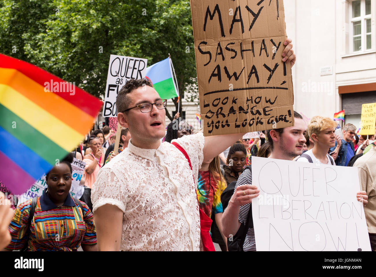 London, UK. 8th July, 2017. Man holding protest sign against Theresa May during Pride London 2017. Thousand of people join the annual LGBT  parade through the capital. Credit: Nicola Ferrari/Alamy Live News Stock Photo