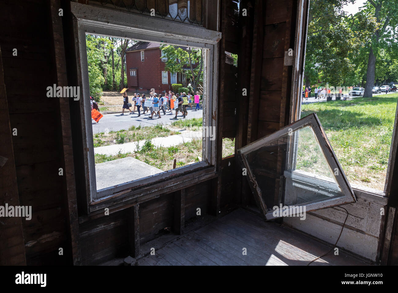 Detroit, Michigan, USA. 8th July, 2017. Detroit residents march through the Islandview neighborhood to protest lack of support for the city's neighborhoods. They say investment has been concentrated downtown, while neighborhood schools, libraries, and recreation centers have been closed and low-income residents displaced by mortgage and tax foreclosures. They say long-time residents are now threatened by gentrification of parts of their community. Credit: Jim West/Alamy Live News Stock Photo