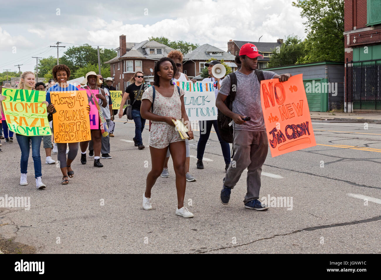 Detroit, Michigan, USA. 8th July, 2017. Detroit residents march through the Islandview neighborhood to protest lack of support for the city's neighborhoods. They say investment has been concentrated downtown, while neighborhood schools, libraries, and recreation centers have been closed and low-income residents displaced by mortgage and tax foreclosures. They say long-time residents are now threatened by gentrification of parts of their community. Credit: Jim West/Alamy Live News Stock Photo