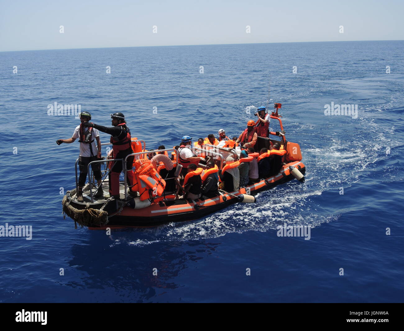 Von einem Schlauchboot im Mittelmeer gerettete Migranten sitzen am 27.06.2017 auf einem Boot der Hilfsorganisationen Ärzte ohne Grenzen und SOS Mediterranee.    (zu dpa 'Grüne weisen Vorwürfe gegen Seenotretter im Mittelmeer zurück' vom 07.07.2017) Photo: Lena Klimkeit/dpa Stock Photo