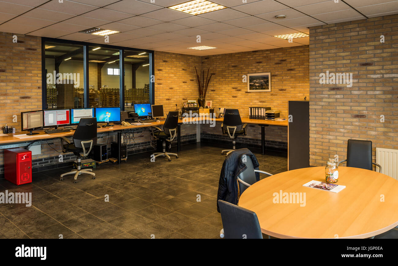 Harmelen, The Netherlands April 3, 2017 Worker at the control computers desk of a tomato