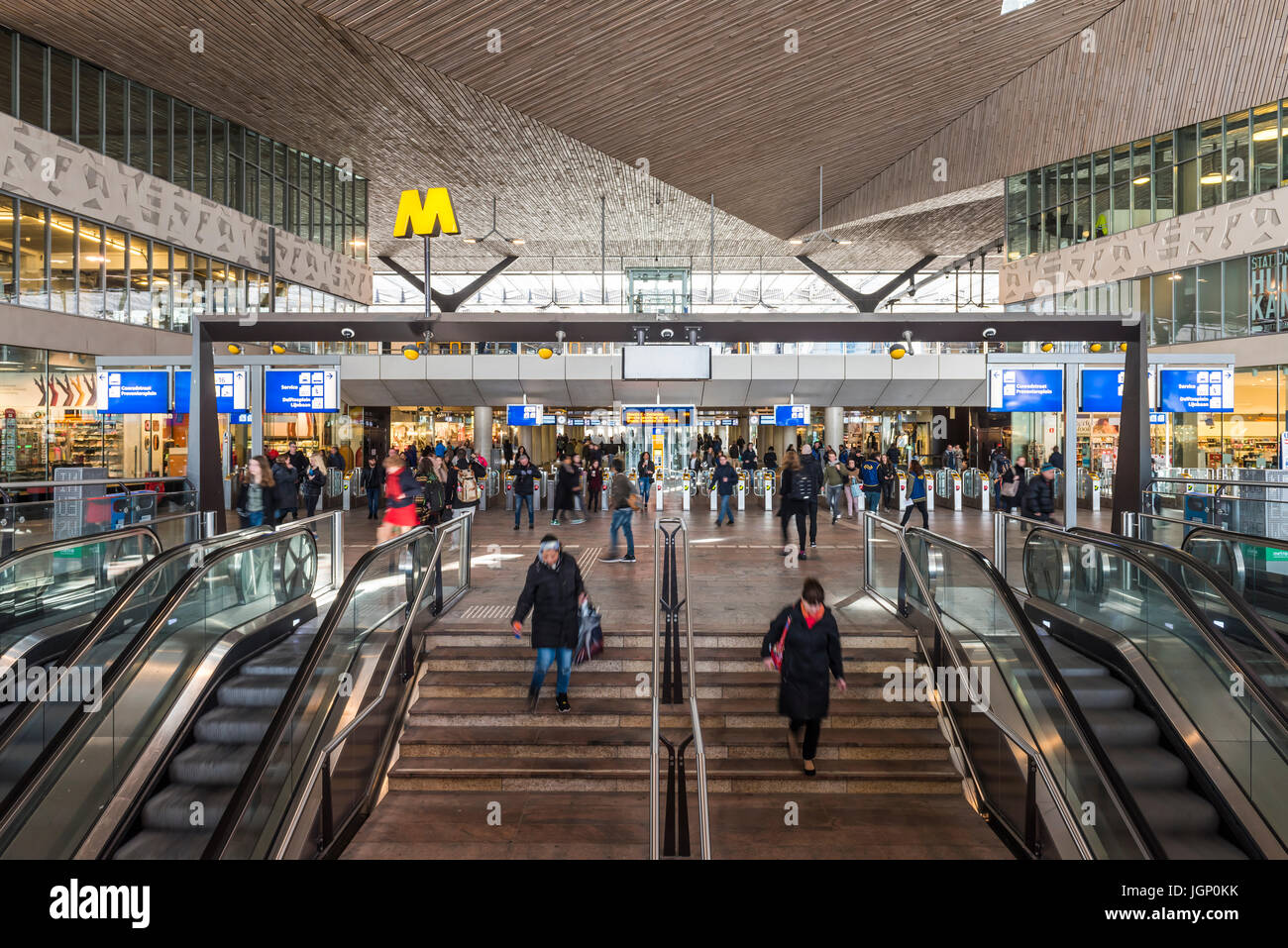 Rotterdam, The Netherlands - March 10, 2017: Interior of modern railway station by architect MVSA in Rotterdam with escalator, stairs and travelers in Stock Photo