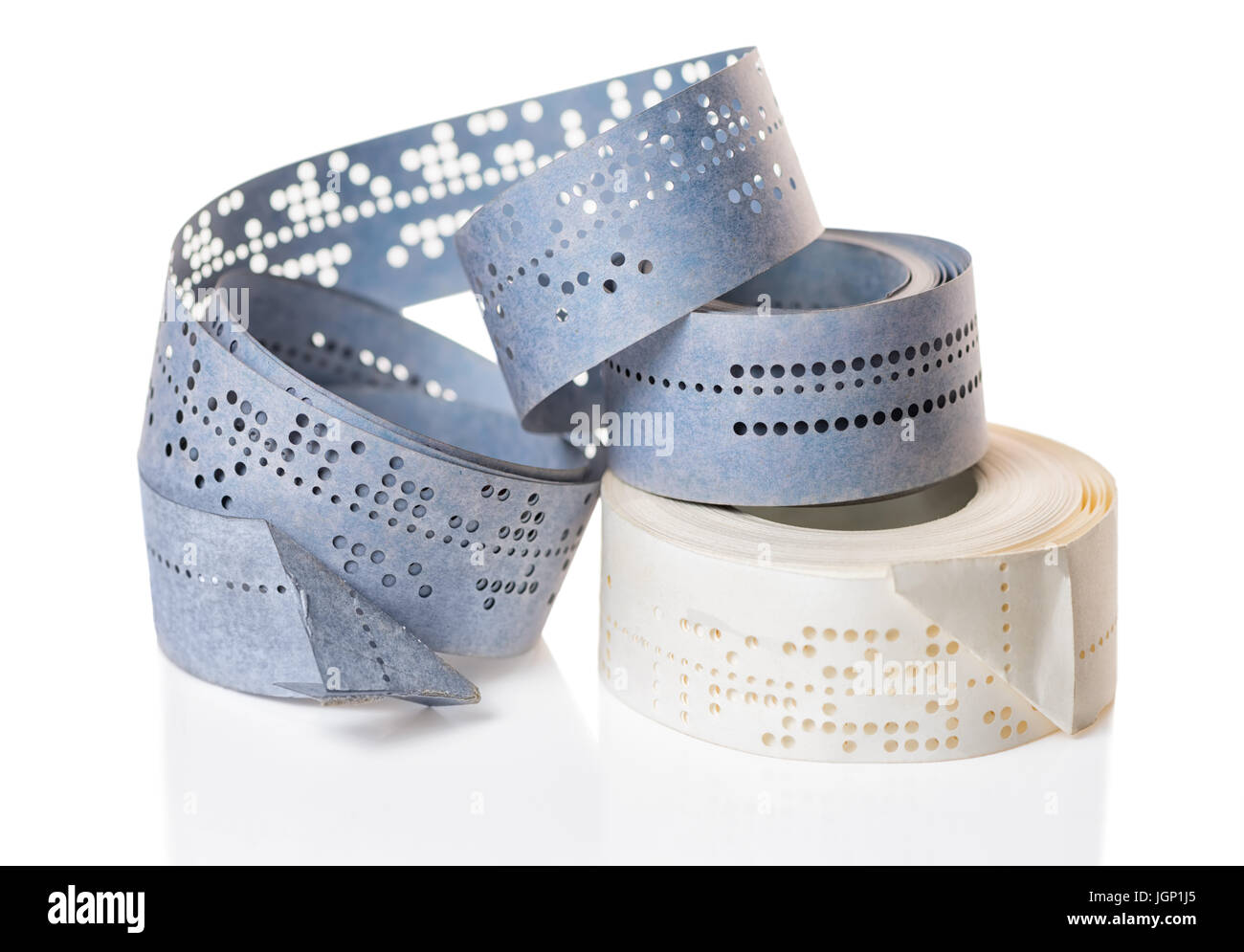 white and blue perforated punched tapes with old data is isolated on background, close up Stock