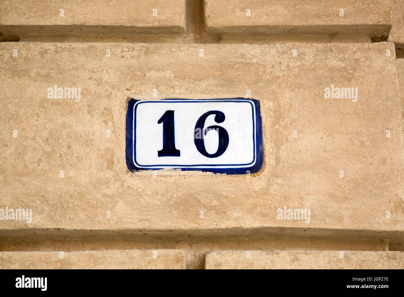 Number Sixteen on Stone Wall Stock Photo - Alamy
