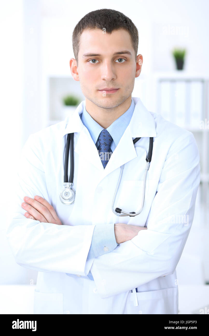 Friendly male doctor in the hospital office. Ready to examine and help ...