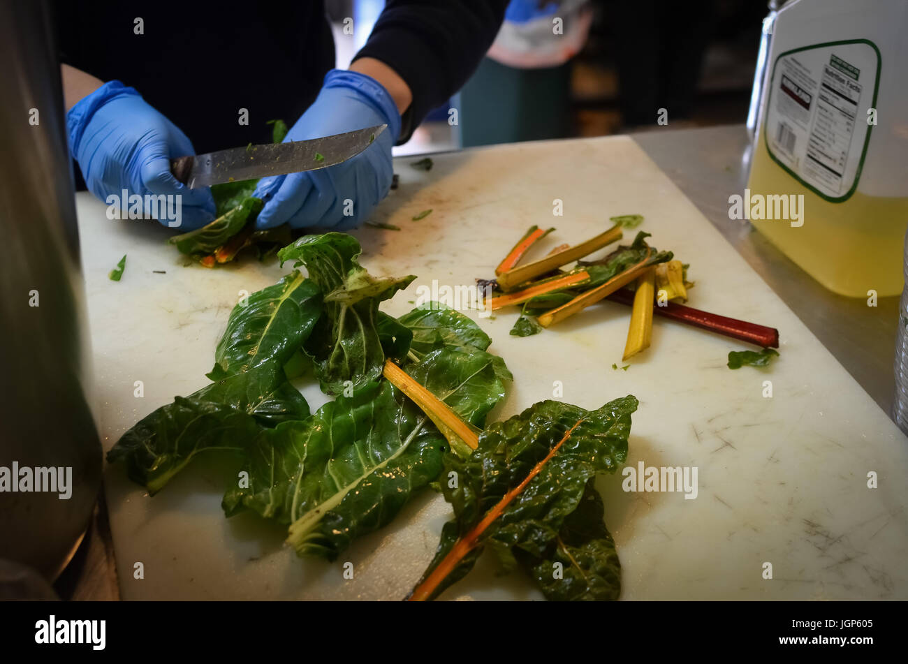 Prepping rainbow chard at a soup kitchen in Davis Stock Photo