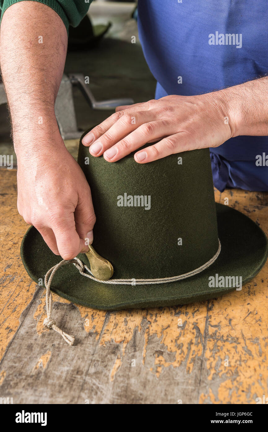 Tightening the shaping cord around a wool felt hat, using iron tool, hatmaker workshop, Bad Aussee, Styria, Austria Stock Photo