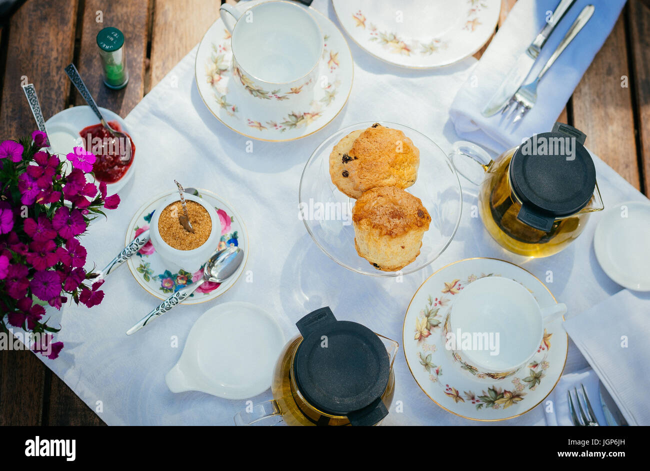 Plates, cups, scones, and tea for afternoon tea Stock Photo