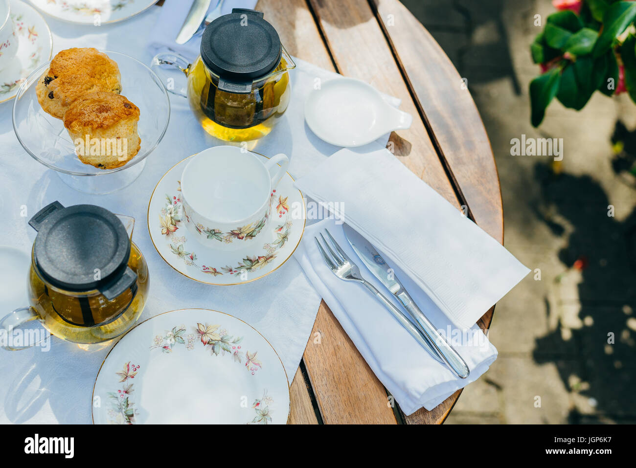 Plates, cups, scones, and tea for afternoon tea Stock Photo