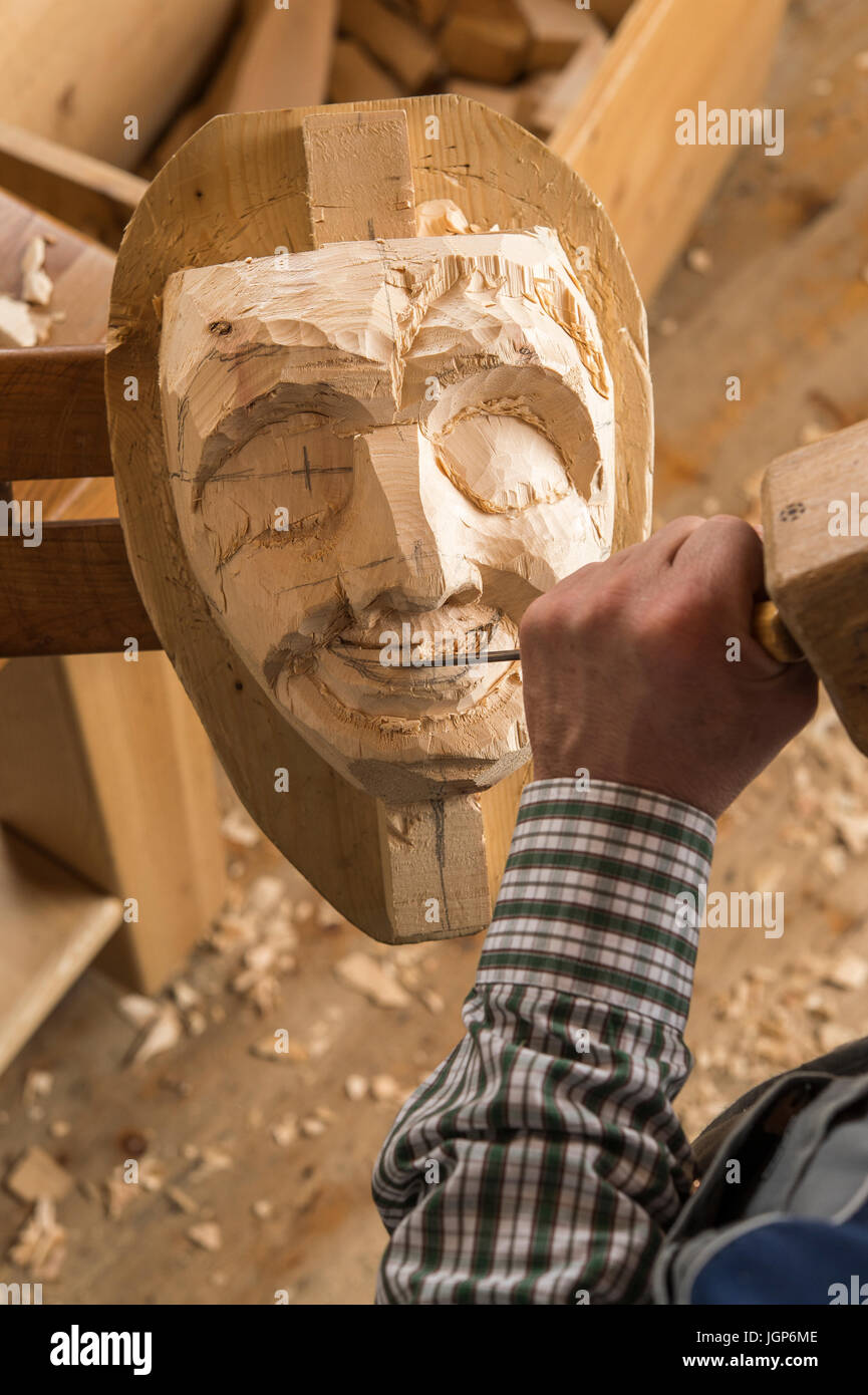 Carving the mouth of a wooden mask using wood carving tools, wooden mask carver, Bad Aussee, Styria, Austria Stock Photo