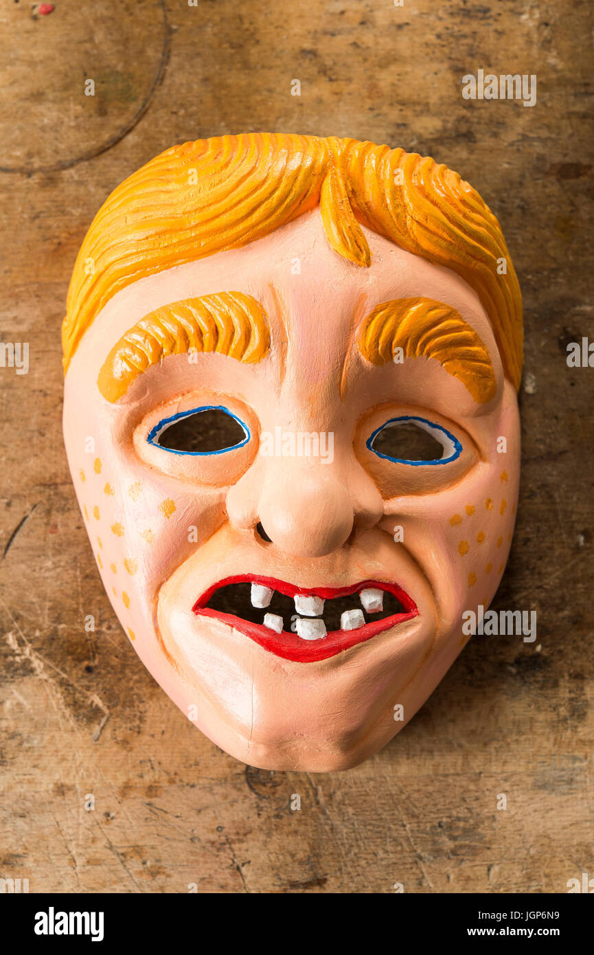 Painted wooden mask on a workbench, wooden mask carver, Bad Aussee, Styria, Austria Stock Photo