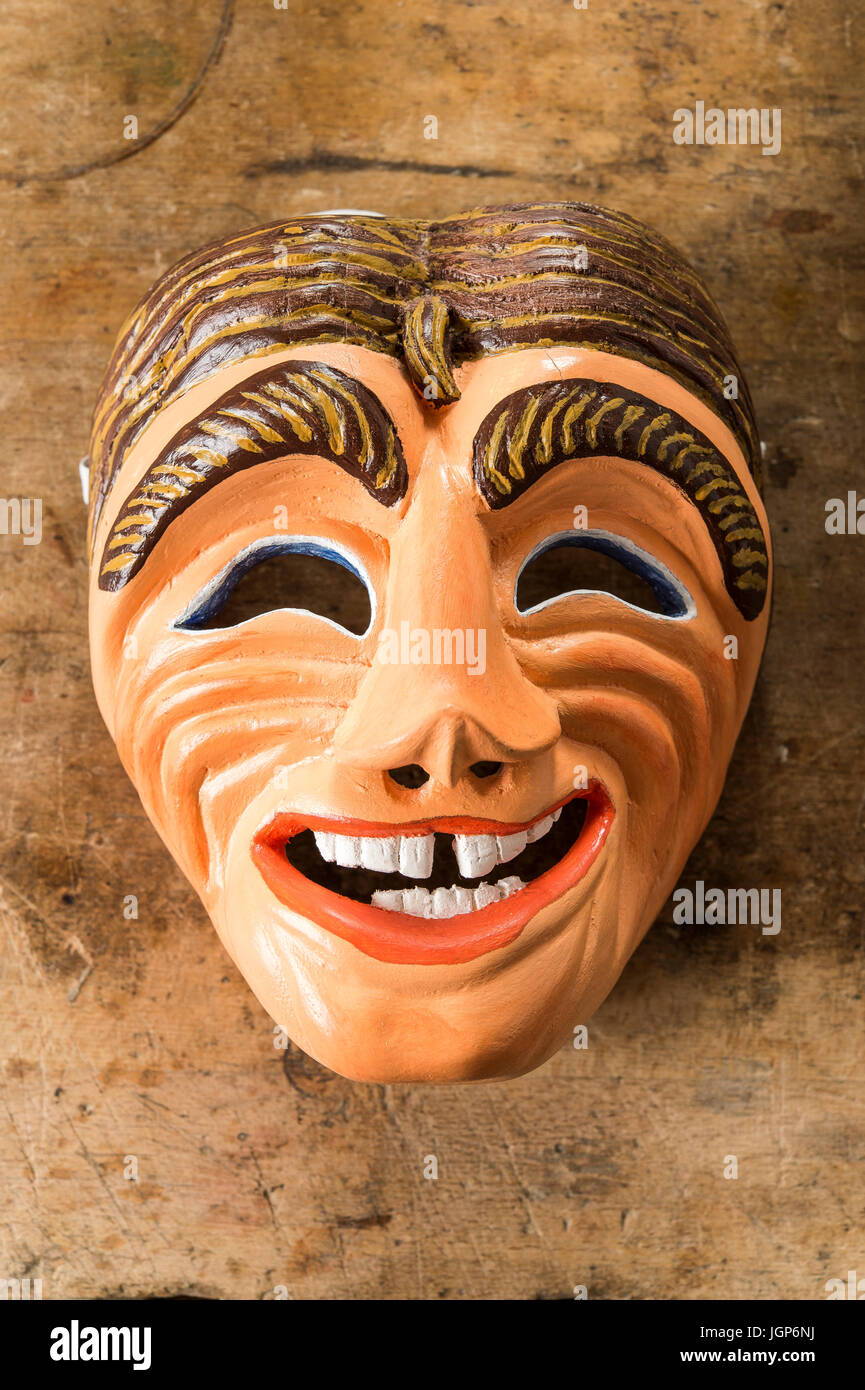 Painted wooden mask on a workbench, wooden mask carver, Bad Aussee, Styria, Austria Stock Photo