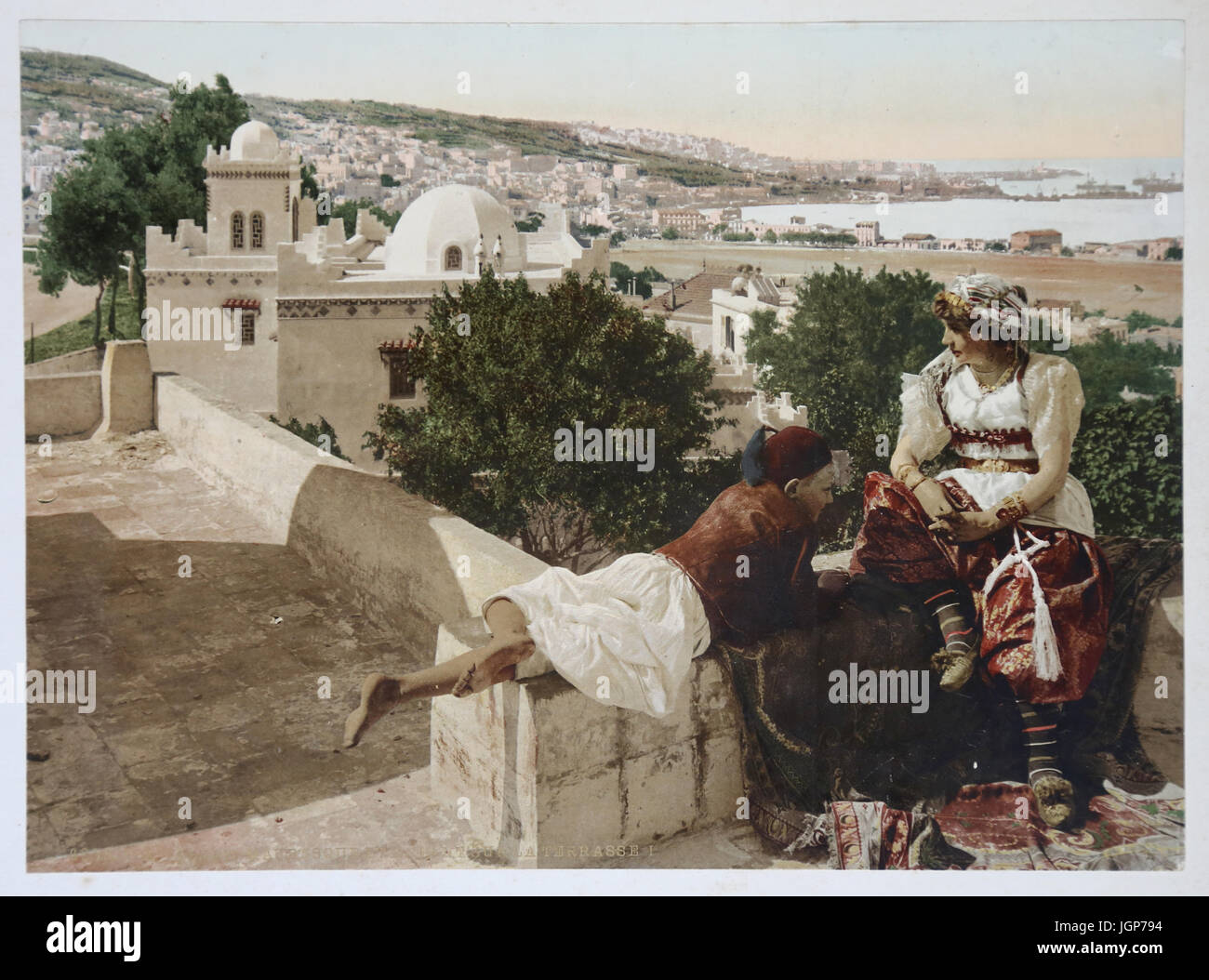 Moorish woman and child, terrace in Algiers. Algeria (ca.1899). Photochrome print. Part of a photo album. Stock Photo