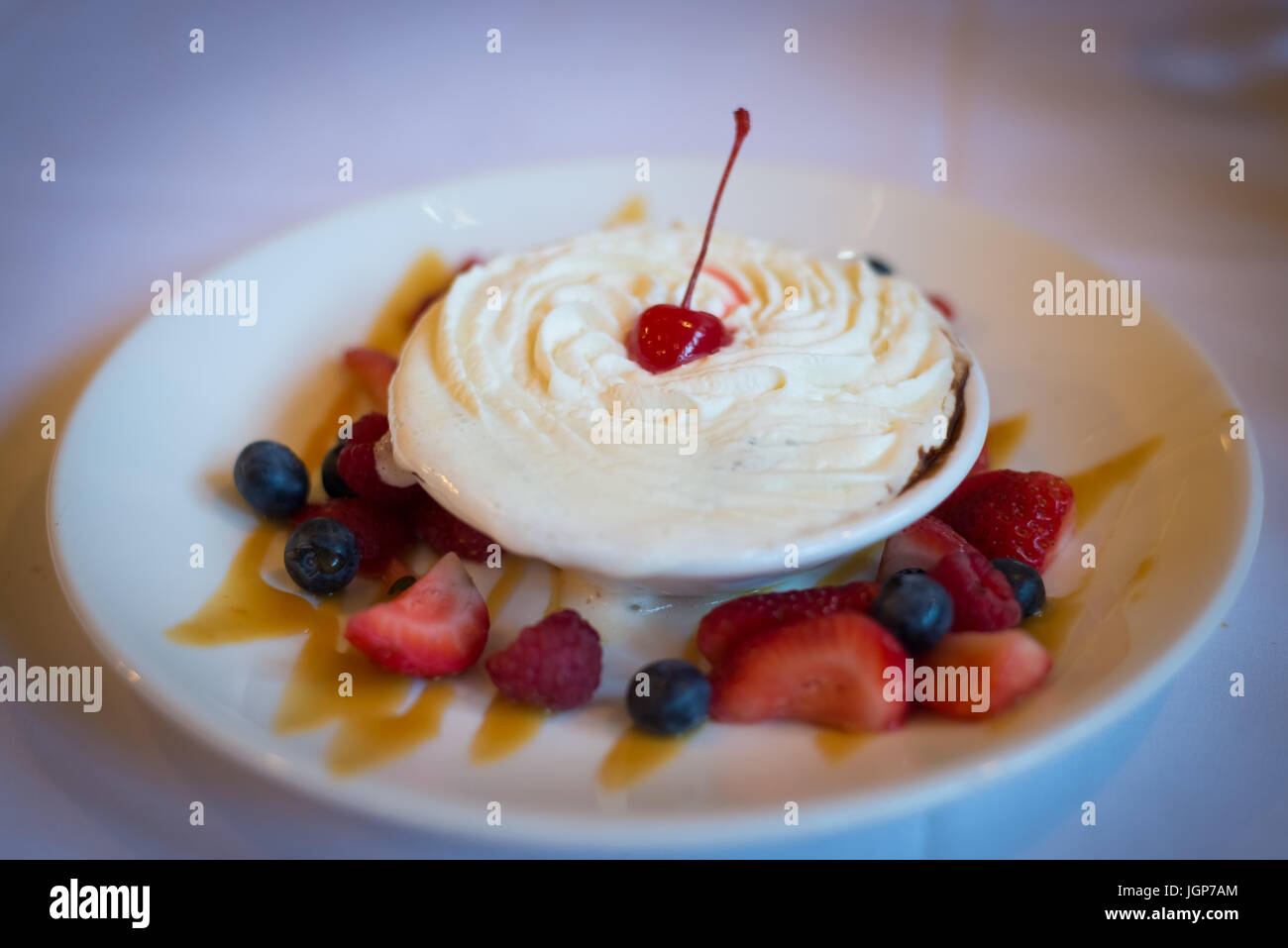 Whipped cream covered cake surrounded by berries Stock Photo Alamy