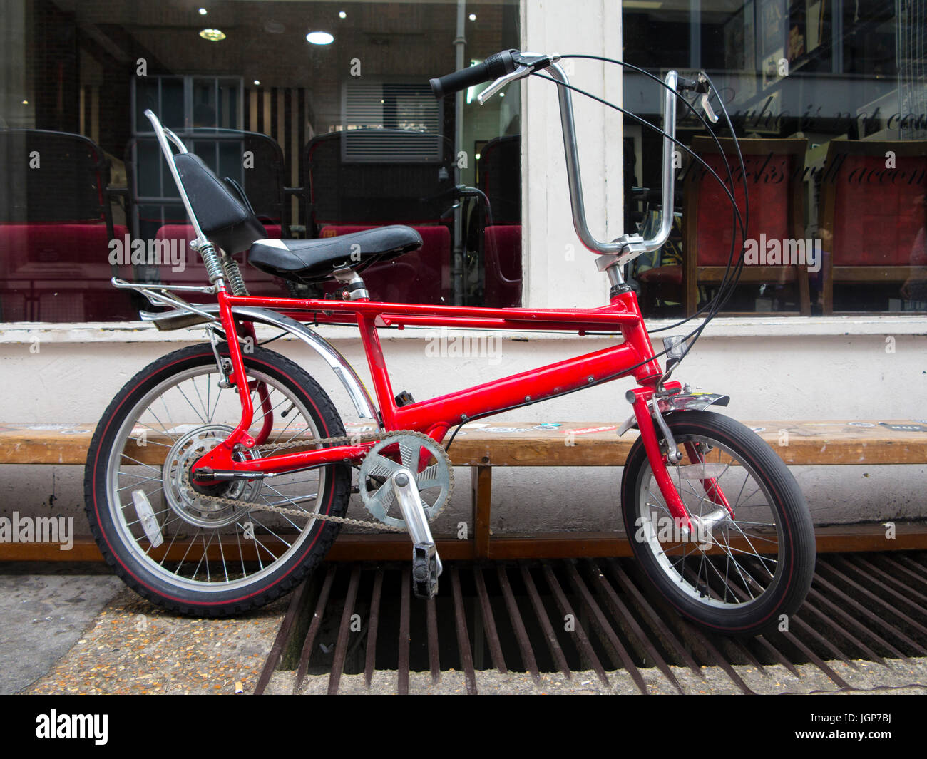 A 1970's chopper bike outside a barber's shop in London Stock Photo