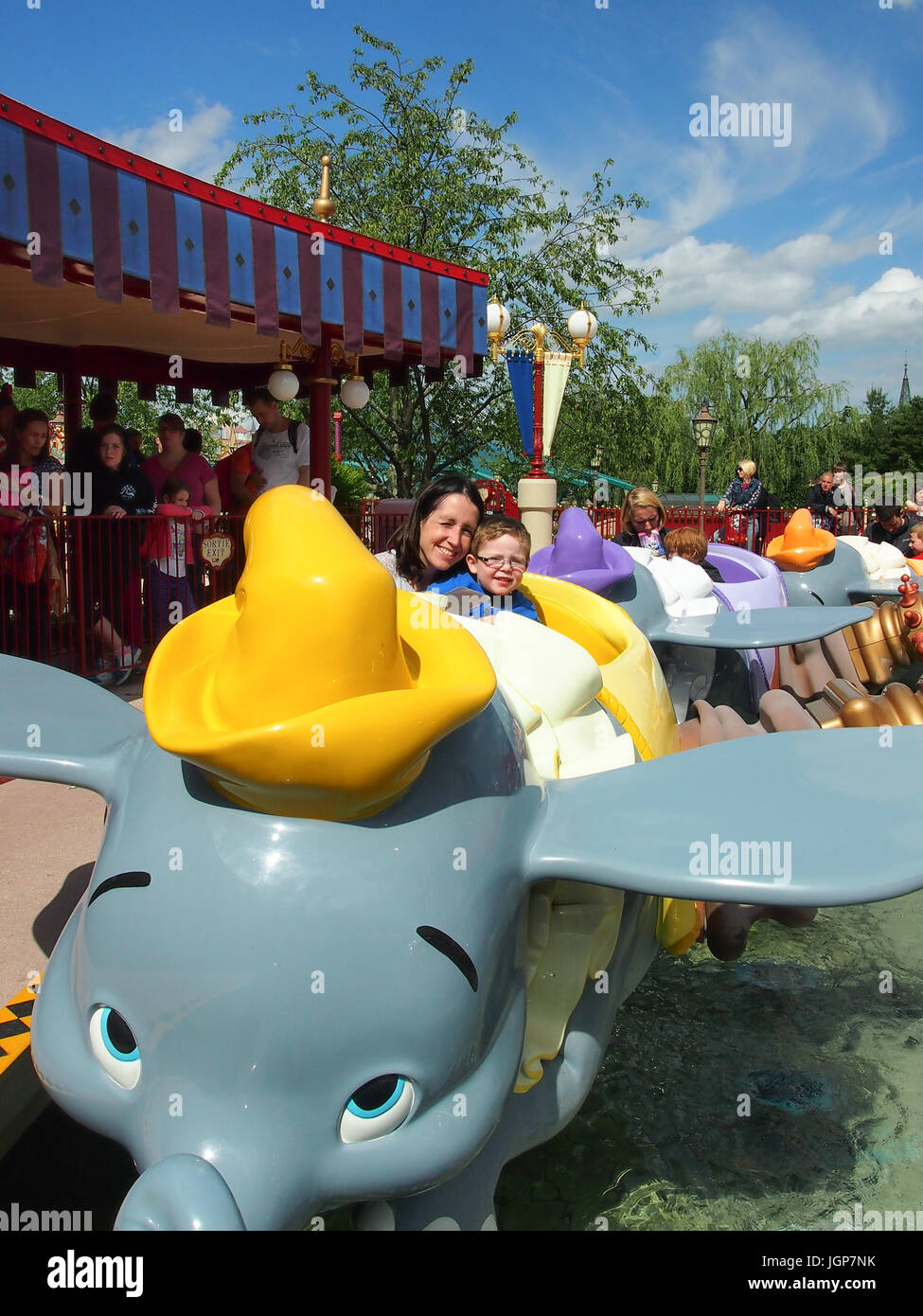 A mother and child ride the Dumbo the flying elephant ride at Disneyland Paris Stock Photo