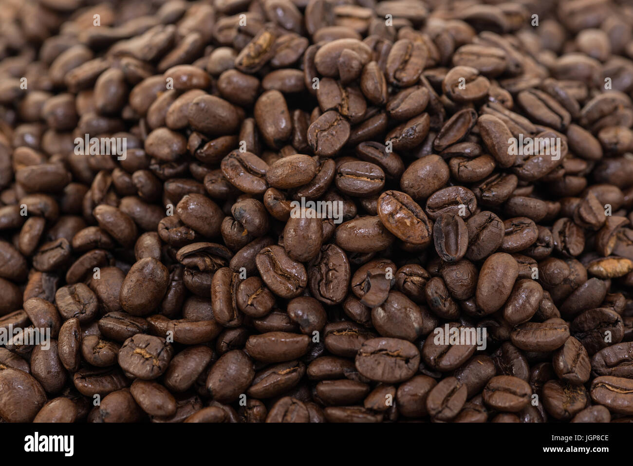 Coffee beans close up and piles on white background Stock Photo - Alamy