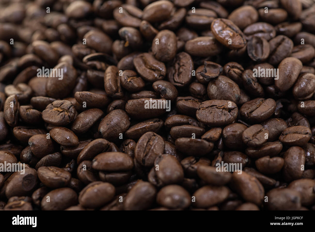 Coffee beans close up and piles on white background Stock Photo - Alamy