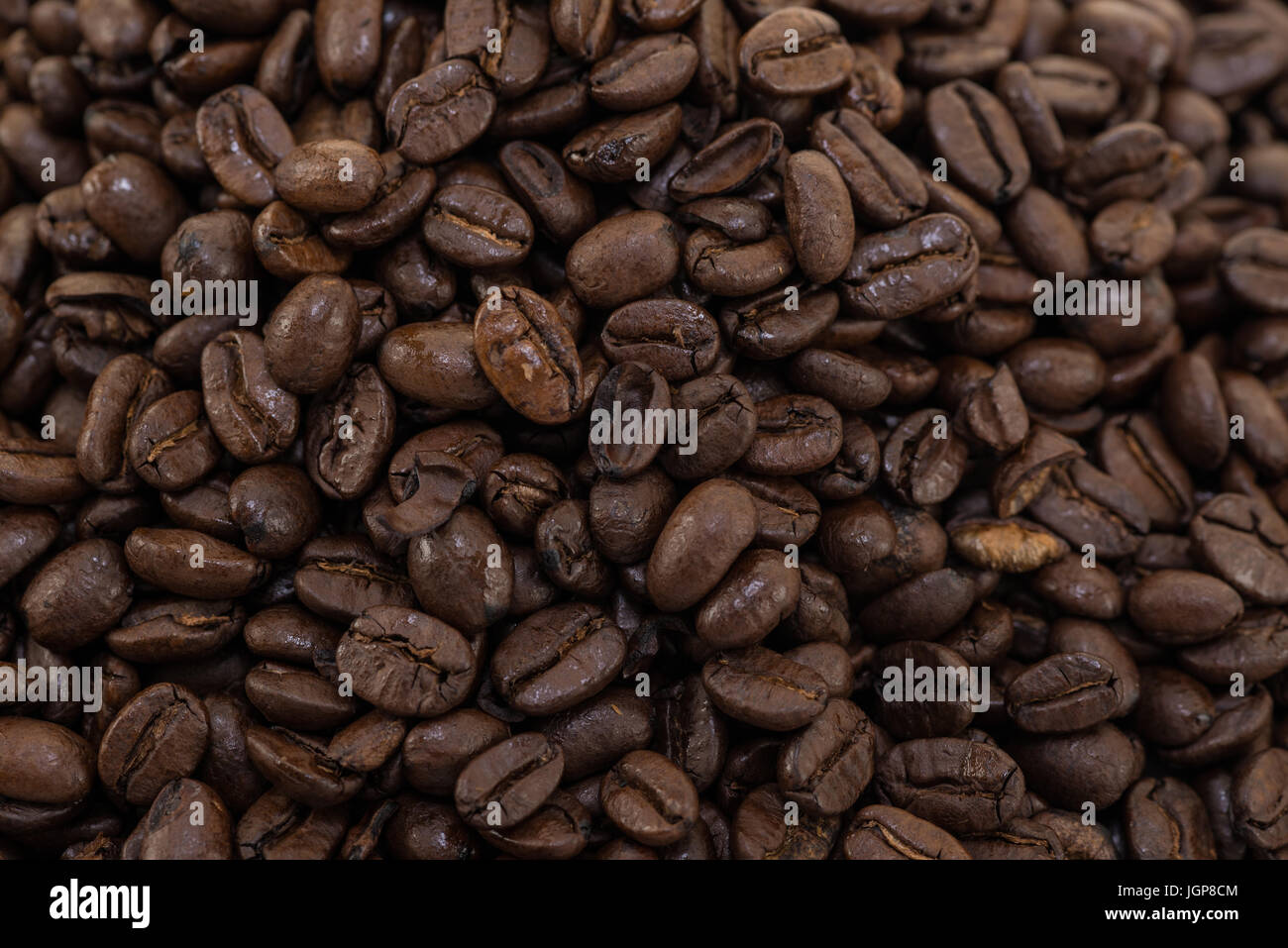 Coffee beans close up and piles on white background Stock Photo - Alamy