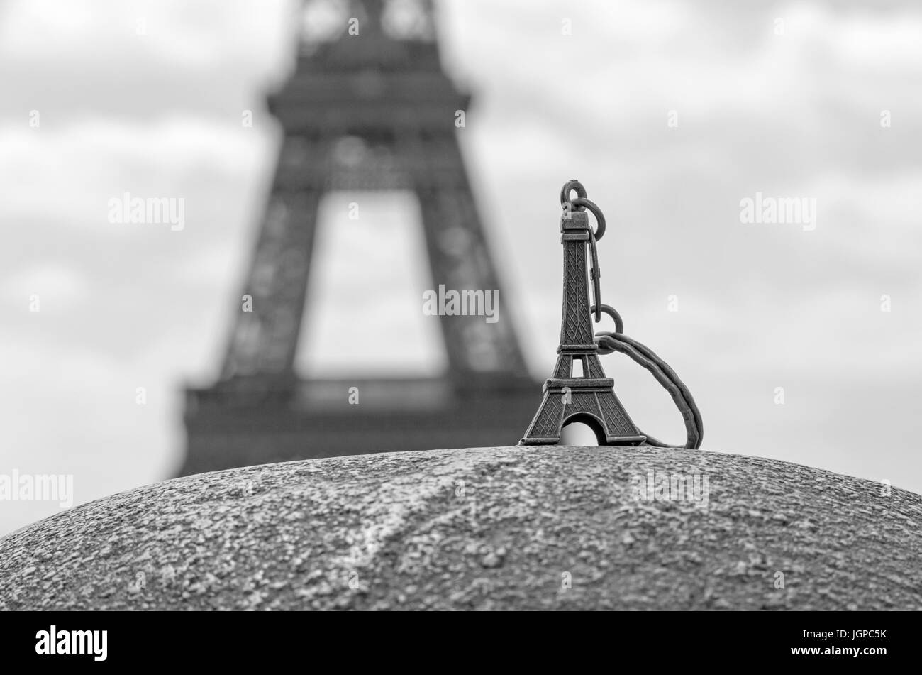 Eiffel tower keychain against real Eiffel tower Stock Photo